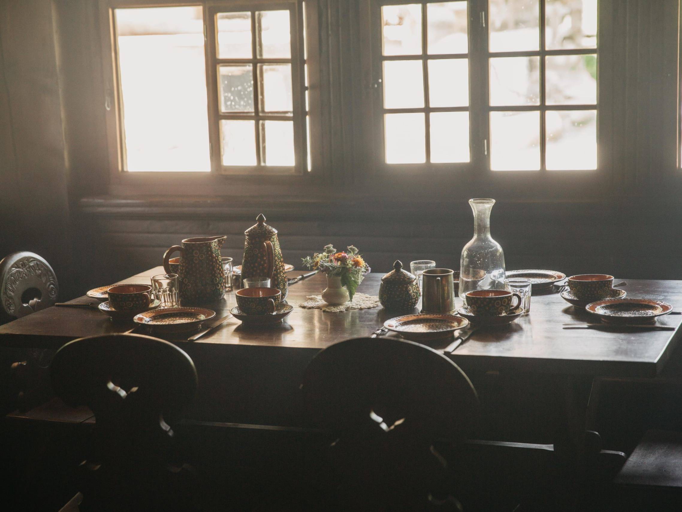 person taking photo of dining table with tablewares