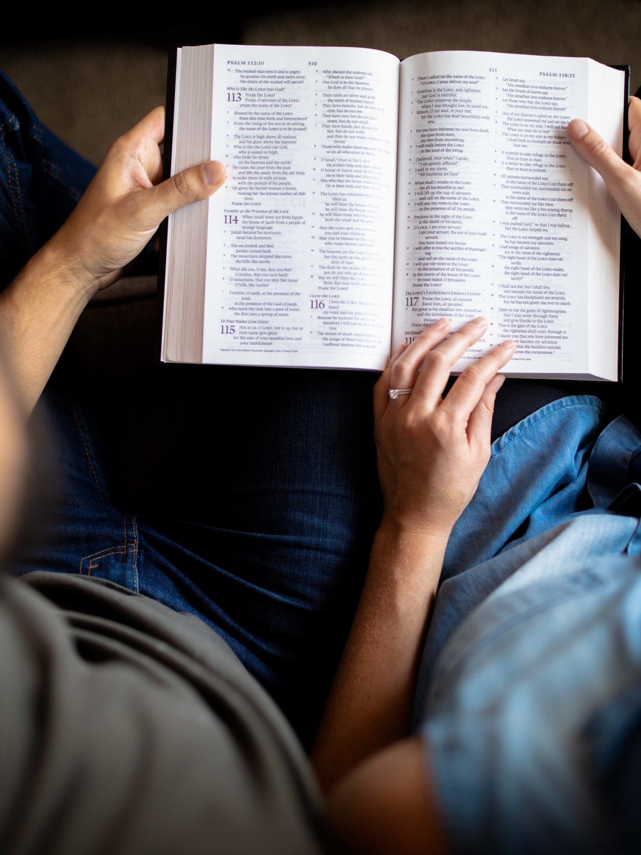 couple reading book on couch