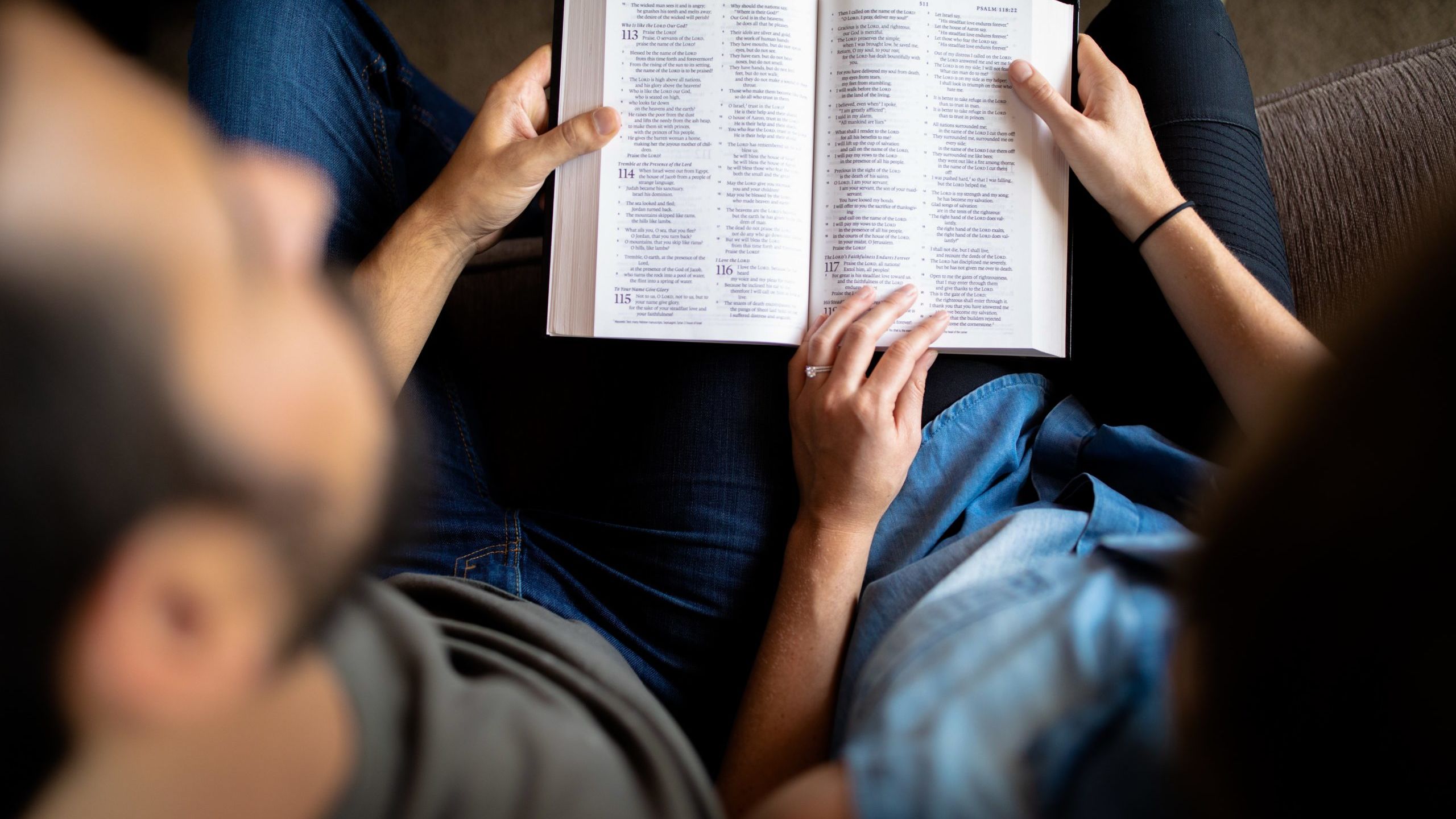 couple reading book on couch