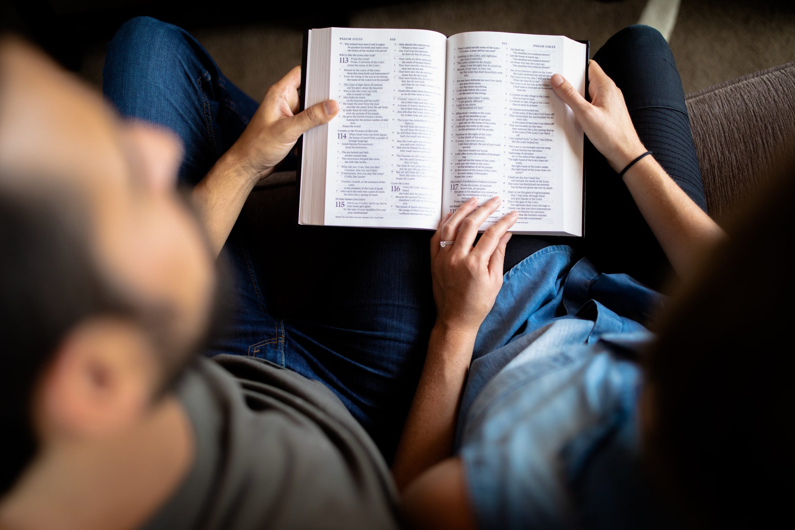 couple reading book on couch