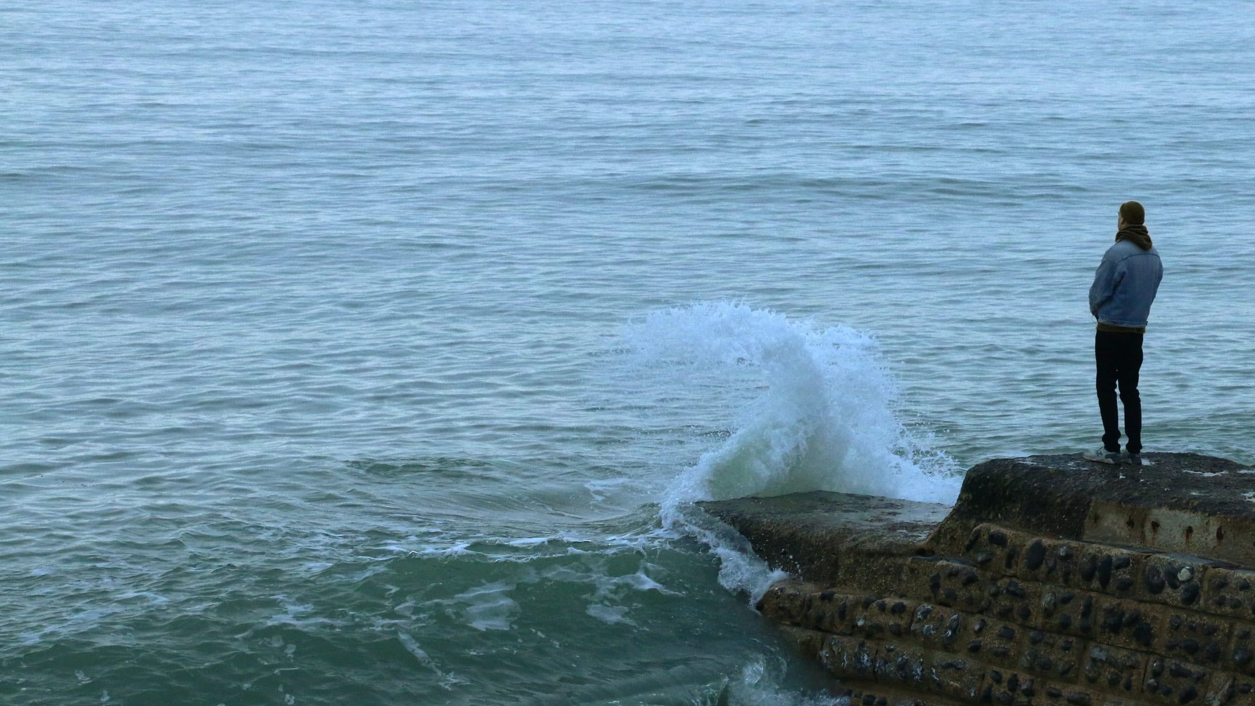 brown rock formation on sea during daytime