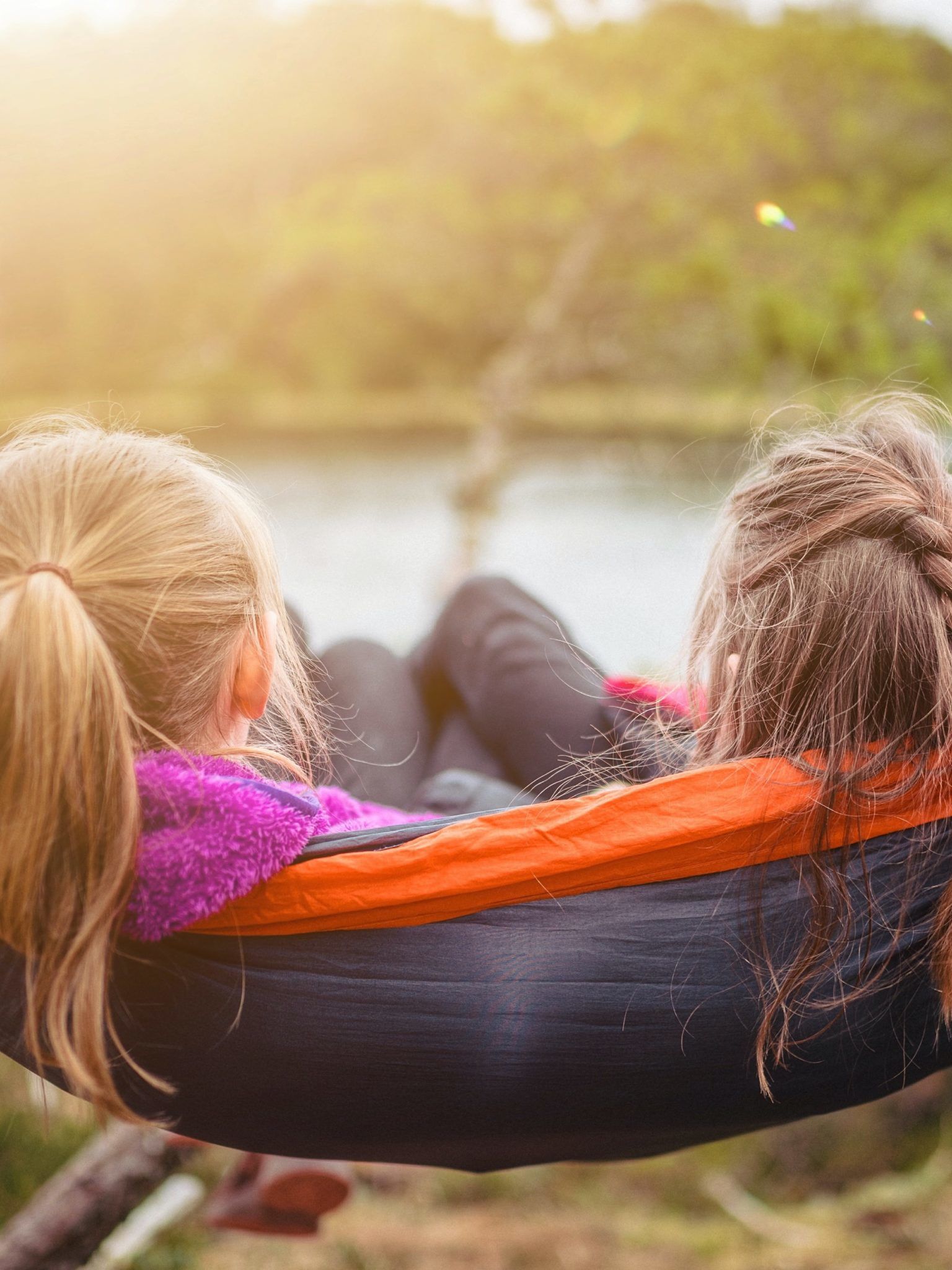 two women lying on hammock