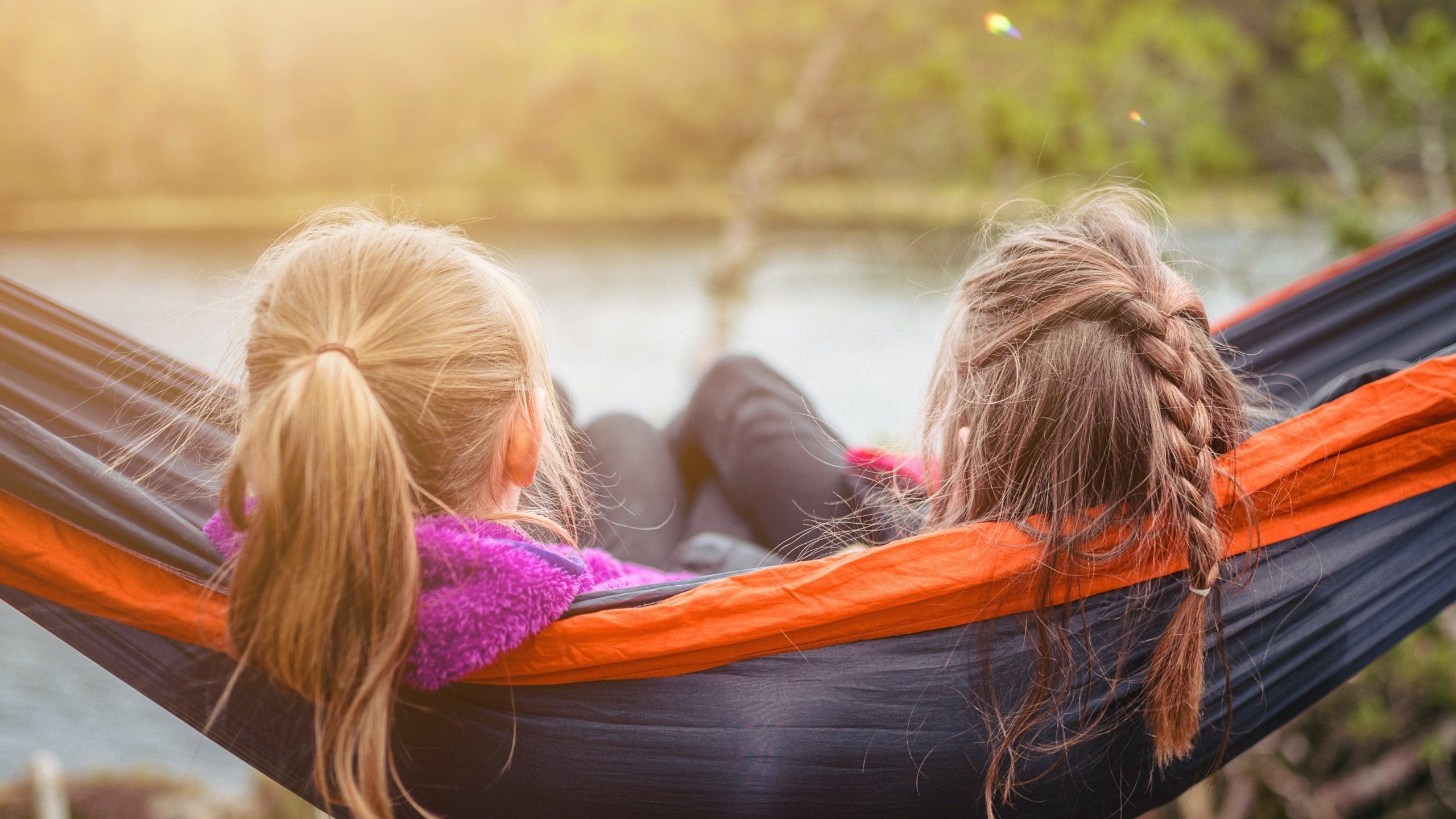 two women lying on hammock