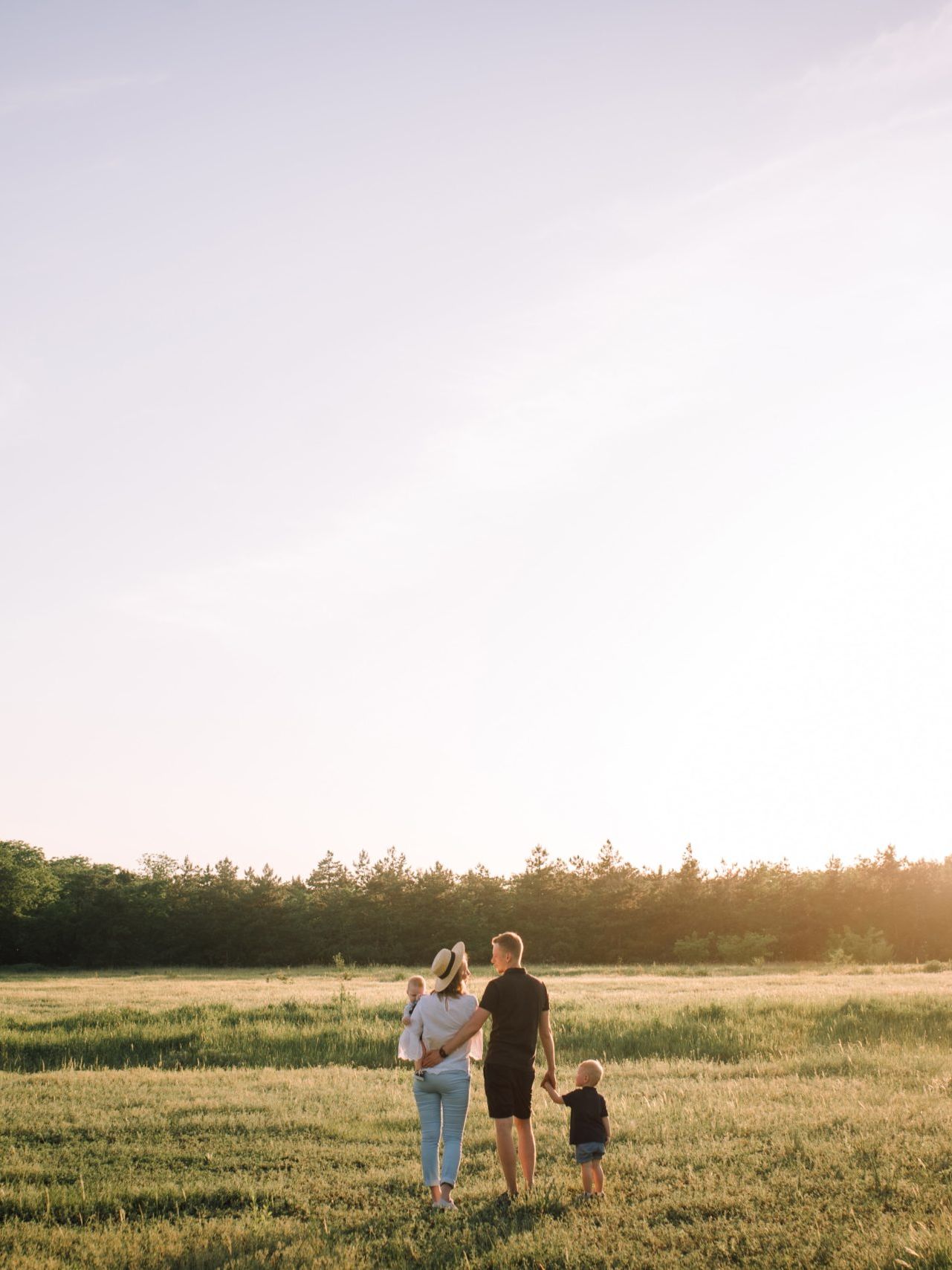 man and woman walking on green grass field during daytime