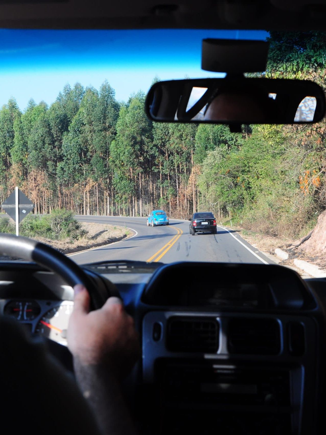 man driving a car on a road