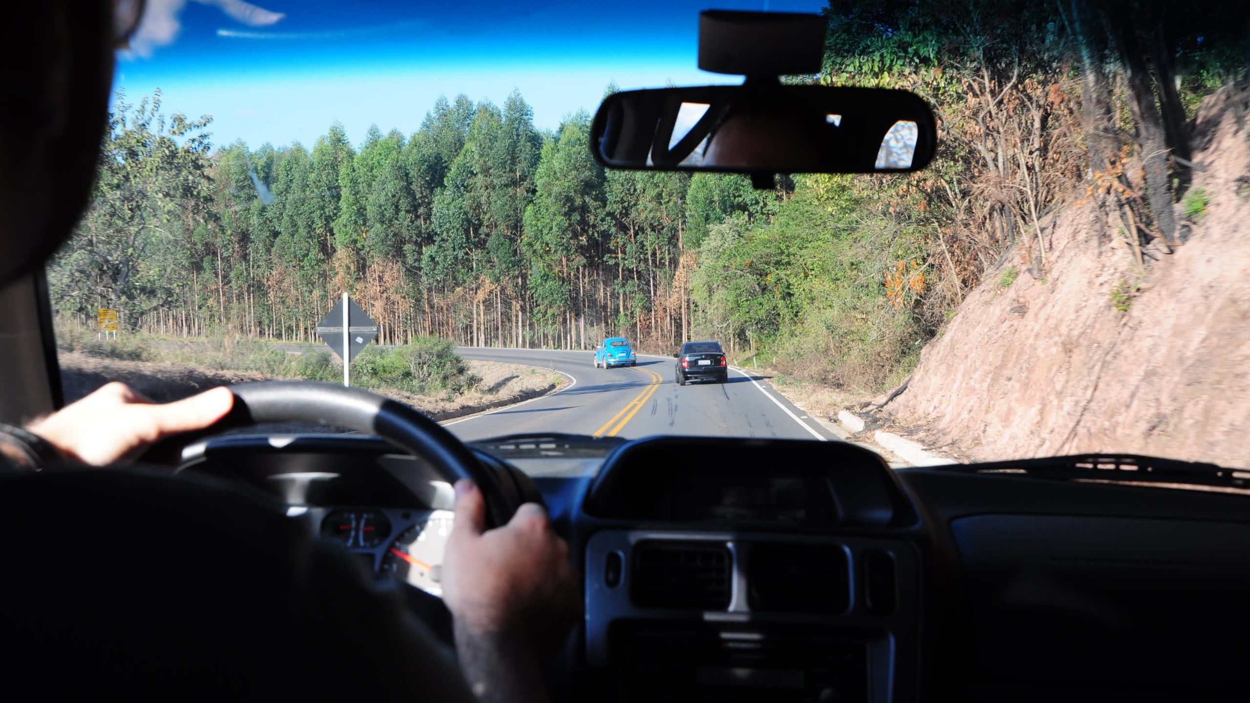 man driving a car on a road