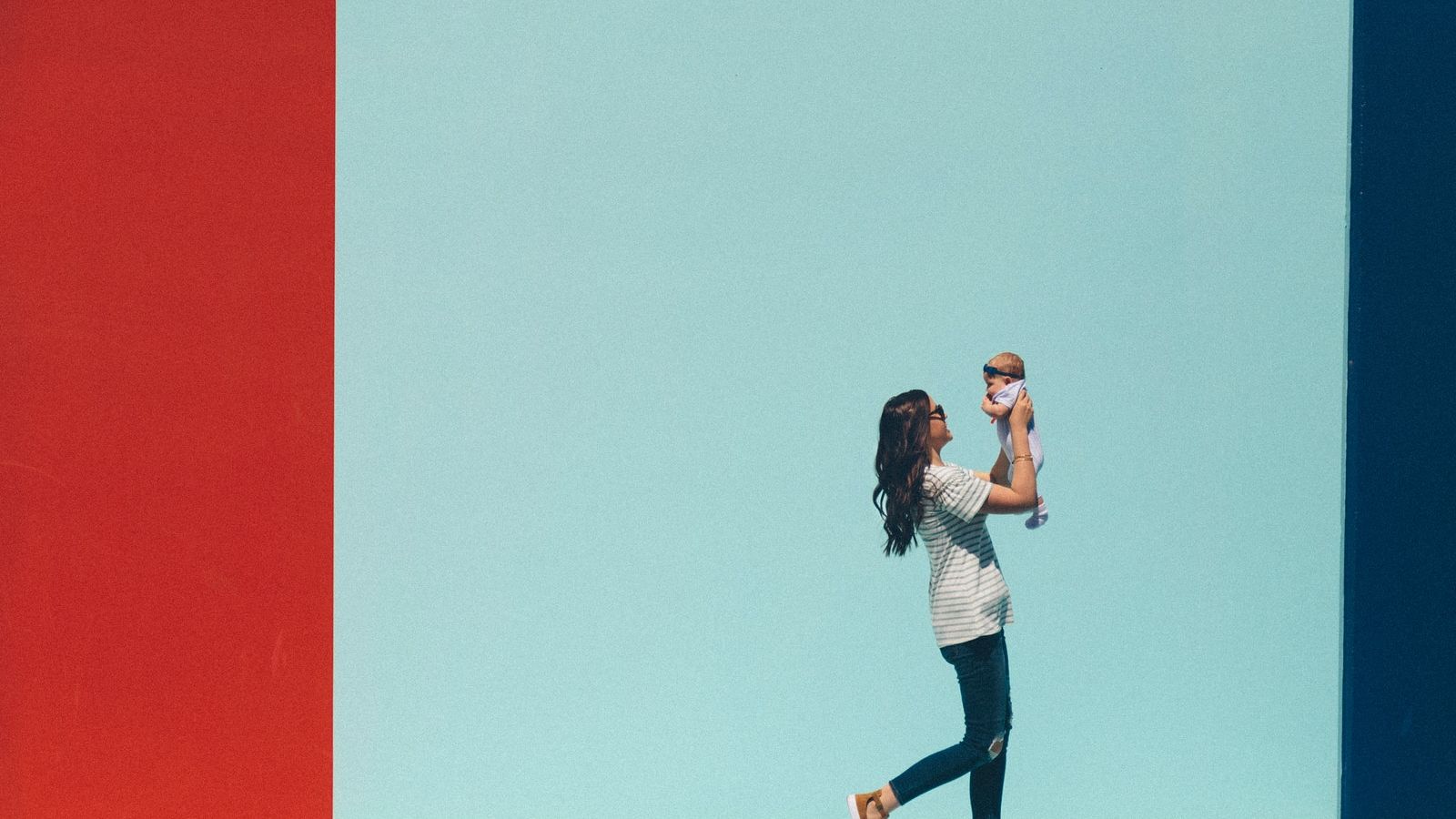 woman carrying baby while walking