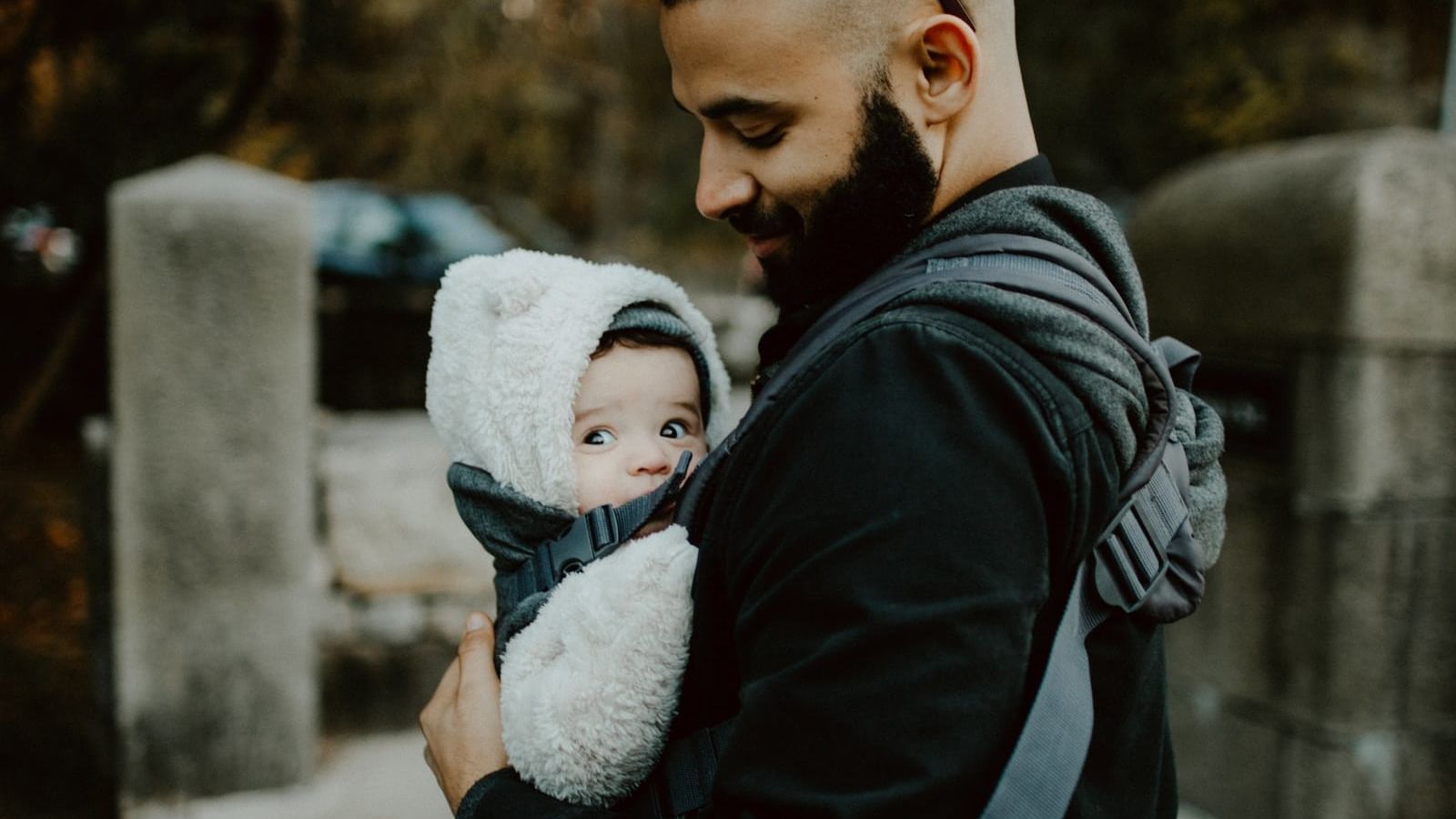 man carrying baby