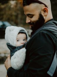 man carrying baby