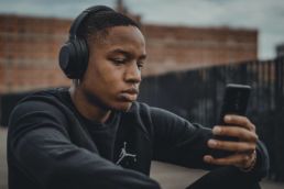 man in black nike hoodie wearing black headphones