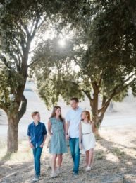 family standing in front of trees