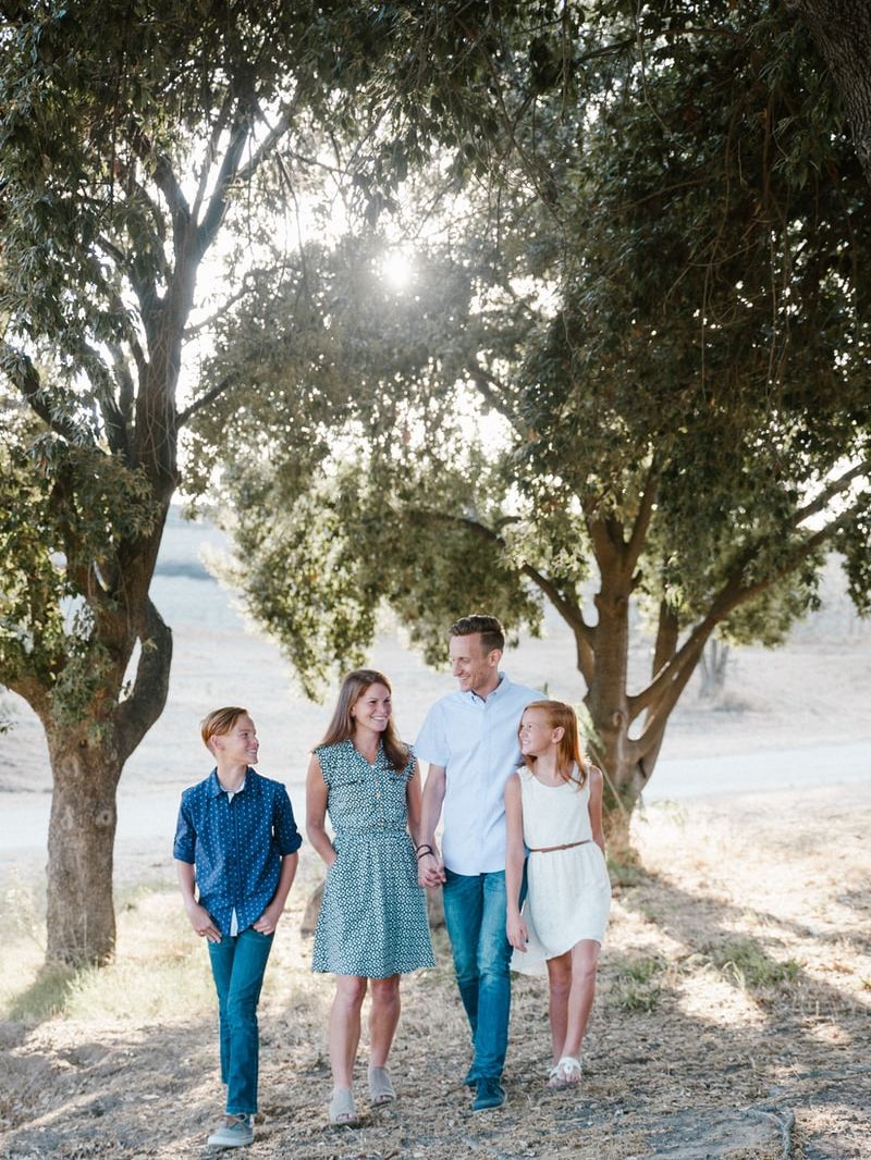 family standing in front of trees