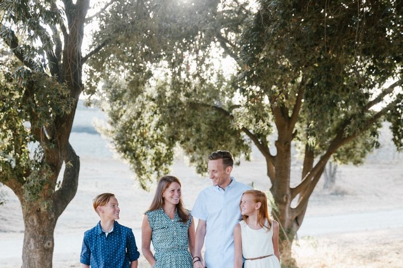 family standing in front of trees