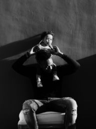 grayscale photography of man lifting a girl