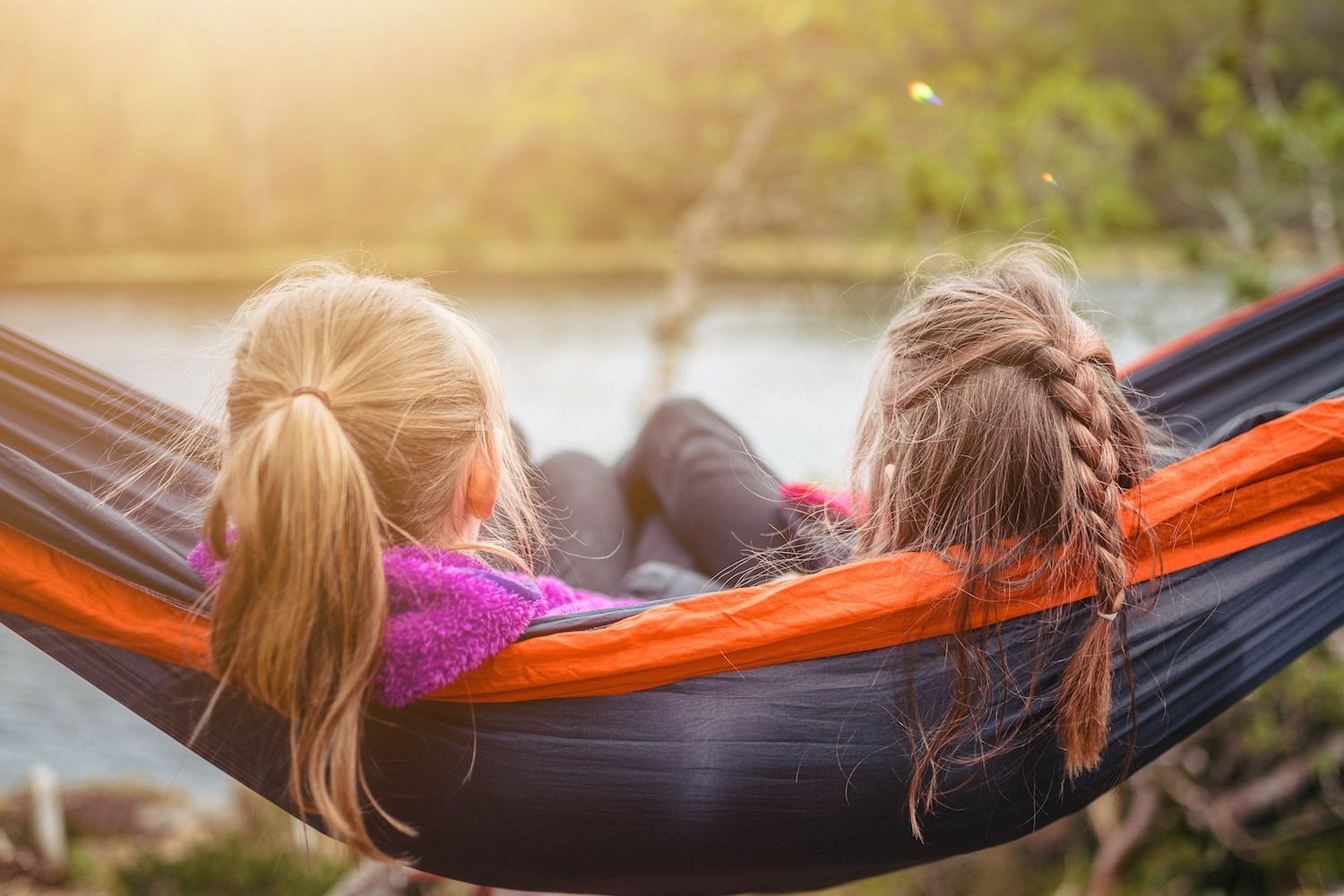 two women lying on hammock