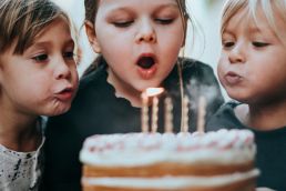boy and girl blowing candles