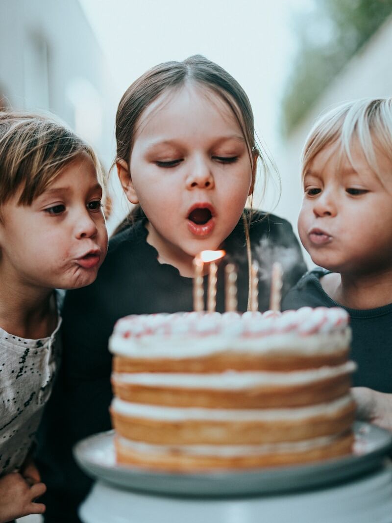 boy and girl blowing candles